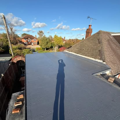 Skilled roofer installing insulation during a renovation.